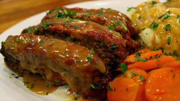 Meatloaf with mushroom gravy, mashed potato and glazed carrots